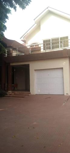 una casa con una puerta de garaje delante de ella en Ypool Pacific Homes, en Kumasi