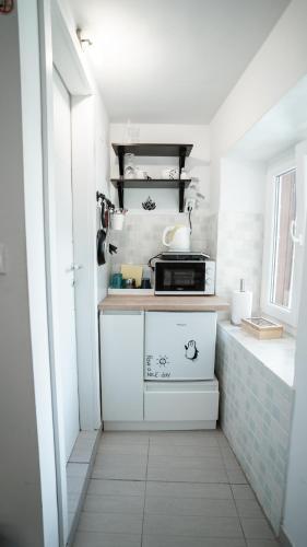a small kitchen with a stove and a microwave at House Gorica in Šibenik