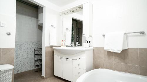 a bathroom with a sink and a toilet and a mirror at House Gorica in Šibenik
