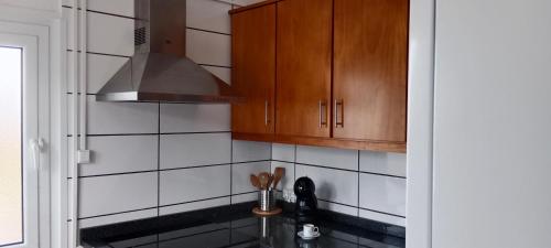 a kitchen with a sink and a stove top oven at Dream View in Pico in Criação Velha
