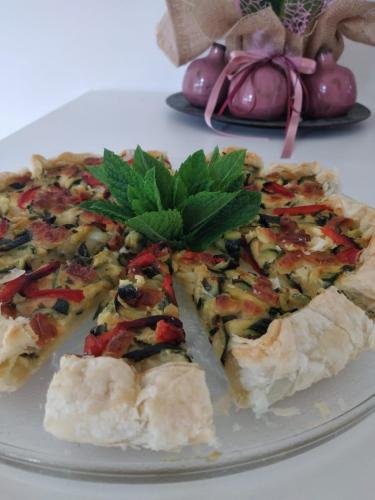 a pizza with a green leaf on a plate at La Casa di Linda in Mirano
