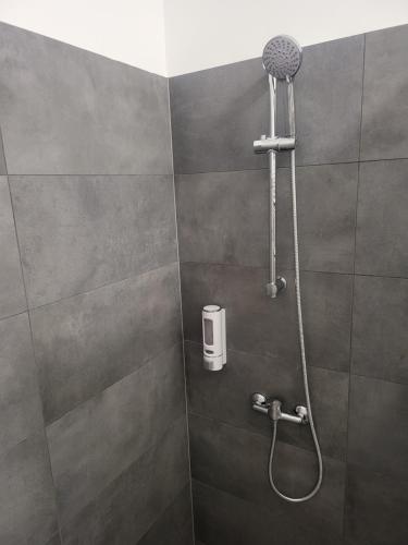 a shower with a shower head in a bathroom at Rooms4Rest Wiertnicza - Private rooms for tourists - ATR Consulting Sp, z o,o, in Warsaw
