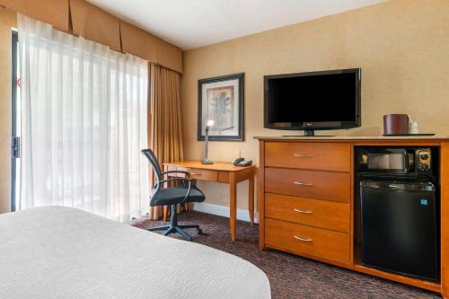 a hotel room with a bed and a flat screen tv at Best Western Plus Placerville Inn in Placerville