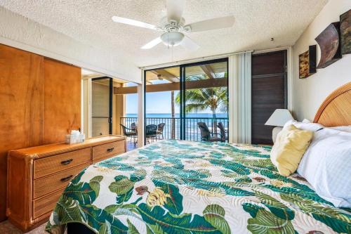 a bedroom with a bed and a view of the ocean at New Top Hawaii Oceanfront 2BR/2BR with White Sand Beach-Kona Bali Kai 206 in Kailua-Kona