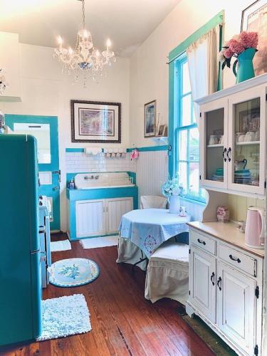 a blue and white room with a table and a window at DOLLHOUSE, 6 BR, French Quarter, JAZZ FEST sleeps 13! in New Orleans