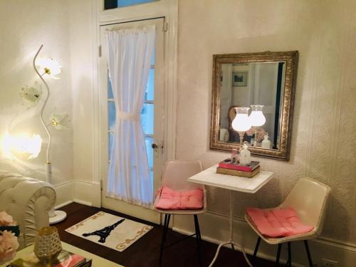 a bathroom with two pink chairs and a mirror at DOLLHOUSE, HUGE 6 BR, French Quarter, STREETCAR sleeps 14! in New Orleans