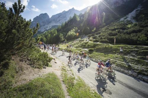 a group of people riding bikes down a mountain road at Pri Piskovih in Grgar