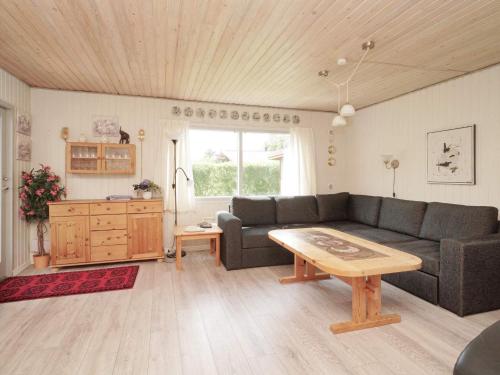 a living room with a couch and a table at 6 person holiday home in Eskebjerg in Eskebjerg