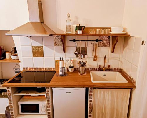 a small kitchen with a counter and a sink at La Casetta Nelle Mura in Terracina