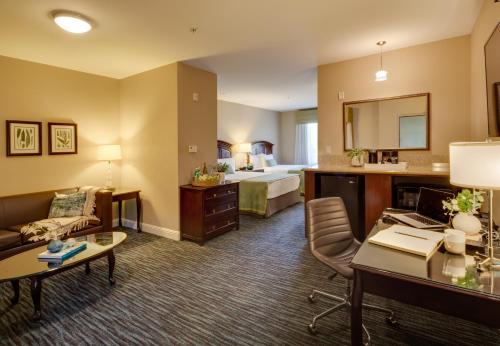 a hotel room with a bed and a desk at Ayres Hotel & Spa Mission Viejo - Lake Forest in Mission Viejo