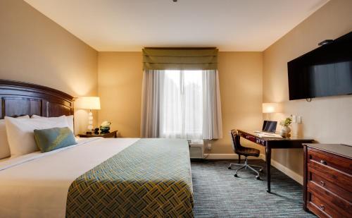 a hotel room with a bed and a desk at Ayres Hotel & Spa Mission Viejo - Lake Forest in Mission Viejo