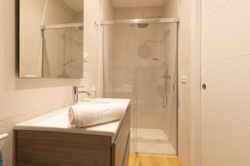 uma casa de banho com um chuveiro, um lavatório e um espelho. em La Terracita de Bisagra em Toledo