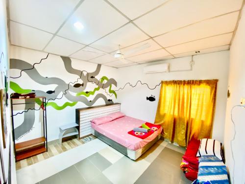 a bedroom with a dinosaur mural on the wall at Padang Besar Homestay Firdaus in Padang Besar