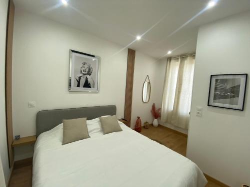 a bedroom with a large white bed with two pillows at CASA DOLCE in Amiens