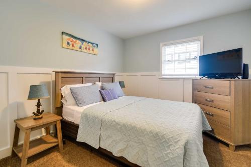 a bedroom with a bed and a dresser with a television at Walk to Atlantic Beach Family Gem with Fenced Yard in Myrtle Beach