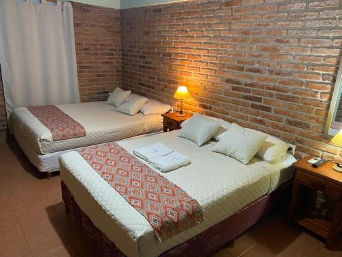 Una cama o camas en una habitación de Hotel Yvy Pyta