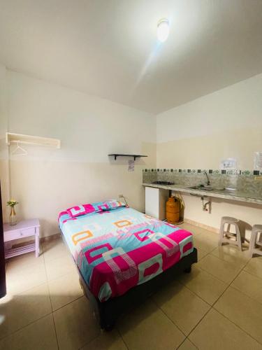 a bedroom with a bed and a table and chairs at Casa de Huéspedes Playas Arena in Playas