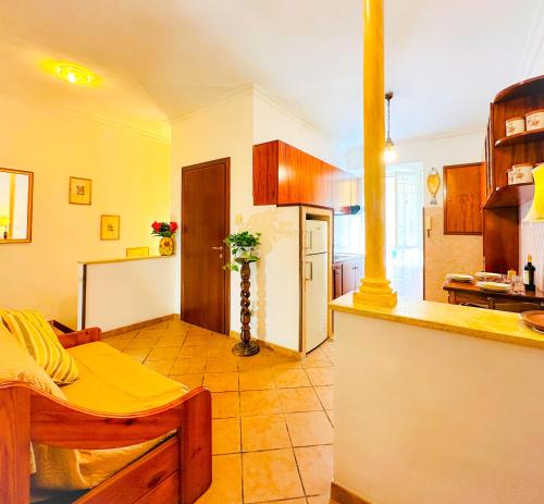 a kitchen with a counter and a kitchen with a refrigerator at Giardino degli Aranci Lulus Home in Rome