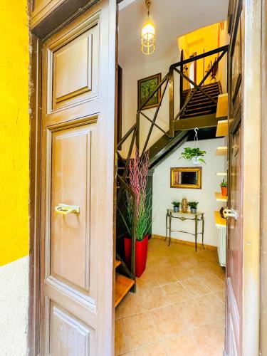 a hallway with a staircase in a house at Giardino degli Aranci Lulus Home in Rome