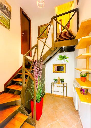 a room with a spiral staircase and a table at Giardino degli Aranci Lulus Home in Rome