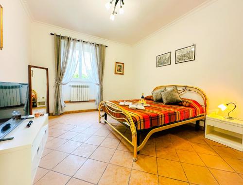 a bedroom with a bed with a table and a television at Giardino degli Aranci Lulus Home in Rome