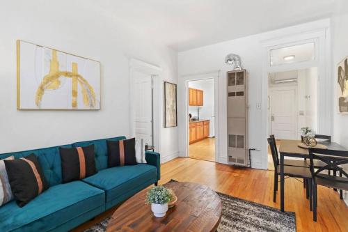 a living room with a blue couch and a table at 2-Bedroom Cozy Apt in Prime Location - Clark 2 in Chicago