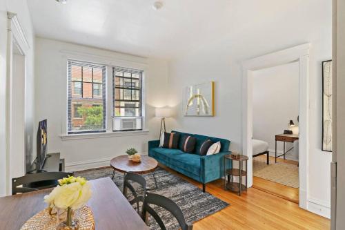 a living room with a blue couch and a table at 2-Bedroom Cozy Apt in Prime Location - Clark 2 in Chicago
