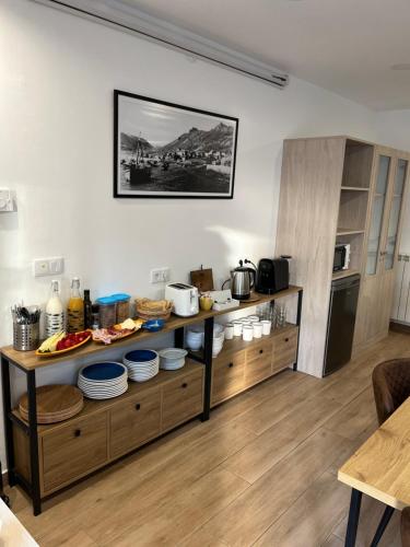 a kitchen with a counter with dishes on it at O Refuxio do Náufrago in Camelle