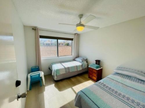 a bedroom with a bed and a window at MarinaView Unit 24 - Break Free Resort- 2 Bedroom Self Contained in Urangan