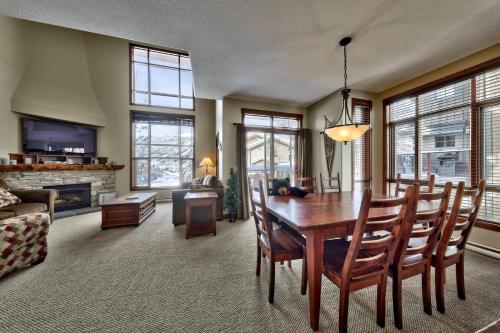 a living room with a dining room table and a couch at Trappers Landing #27 By Bear Country in Sun Peaks