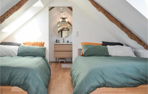two beds in a room with white walls at Amazing Home In Le Vieux-bourg With Private Swimming Pool, Can Be Inside Or Outside in Le Vieux-Bourg