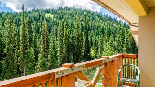 a balcony with a view of a forest of trees at Fireside Lodge #419 By Bear Country in Sun Peaks