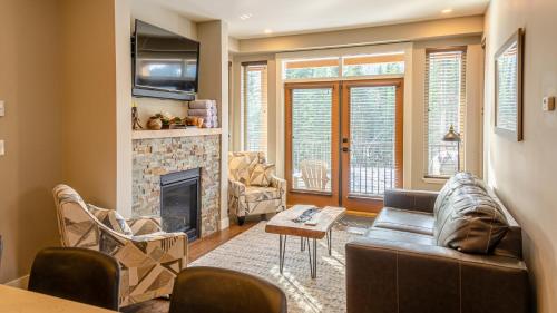 a living room with a couch and a fireplace at Echo Landing #05 by Bear Country in Sun Peaks