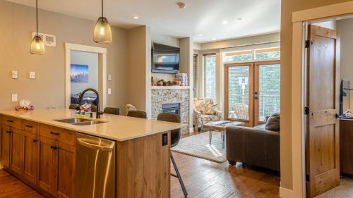 a kitchen and living room with a couch and a table at Echo Landing #05 by Bear Country in Sun Peaks