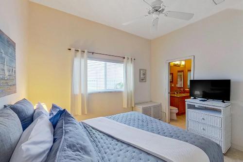 a bedroom with a bed and a flat screen tv at Water View Wonder in Matlacha