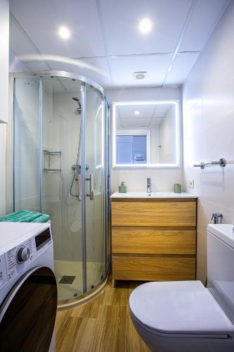 a bathroom with a shower and a toilet and a sink at Port de Xabia IV in Jávea