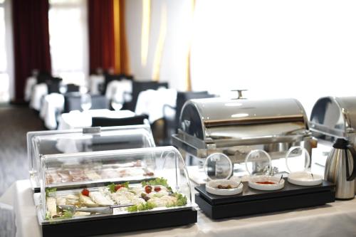 a buffet line with food on a table at Nova City Garni Hotel Signature Collection in Belgrade