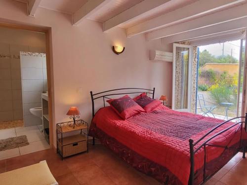 a bedroom with a bed with red sheets and a window at Charming Villa in Villes-sur-Auzon with Swimming Pool in Villes-sur-Auzon