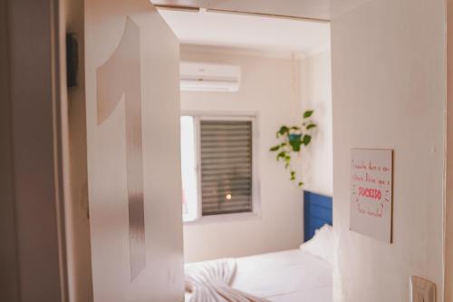 a small room with a bed and a window at Hostel new way in Sao Paulo