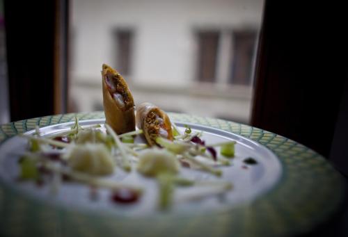 a plate with some food on a table at Auberge du Raisin in Cully