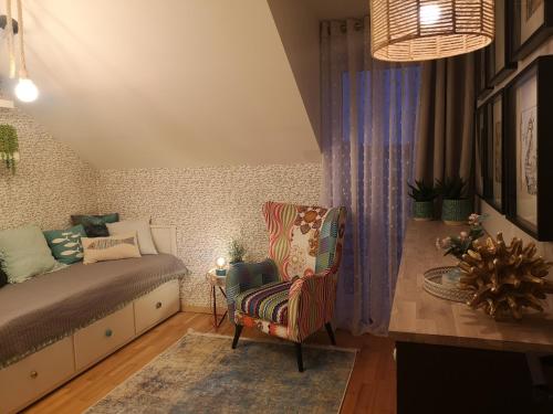 a bedroom with a bed and a chair in it at Glam Design - Beautiful, comfortable and cosy house with garden, free parking and WIFI in Krakow