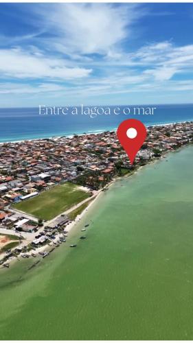 an overhead view of a beach with a red island at Suítes Brandi in Arraial do Cabo