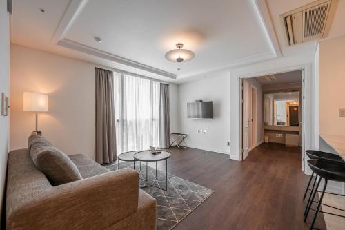 a living room with a couch and a table at Haeundae Centum Hotel in Busan