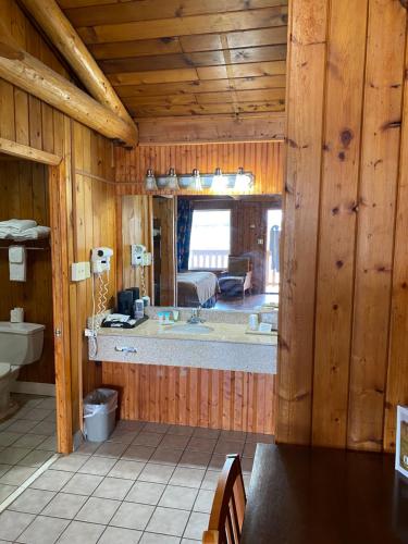a bathroom with a large tub in a log cabin at Atlantic Shores Inn and Suites in Chincoteague