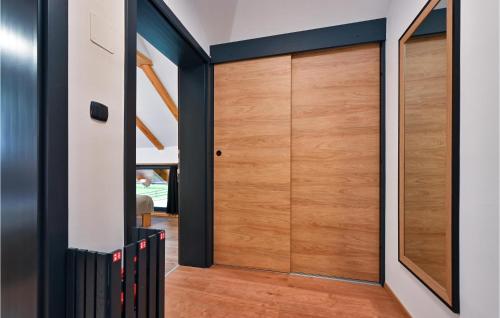 a pivot door in the hallway of a house at Cozy Home In Vitesinec With Sauna in Salinovec