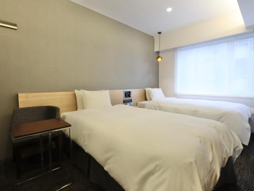 Кровать или кровати в номере HOTEL M's EST KYOTO STATION SOUTH