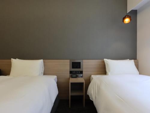 Кровать или кровати в номере HOTEL M's EST KYOTO STATION SOUTH
