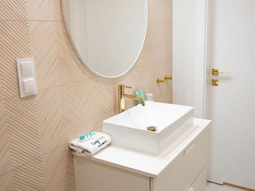 a bathroom with a white sink and a mirror at Apartment in Pobierowo near Baltic Sea in Pobierowo