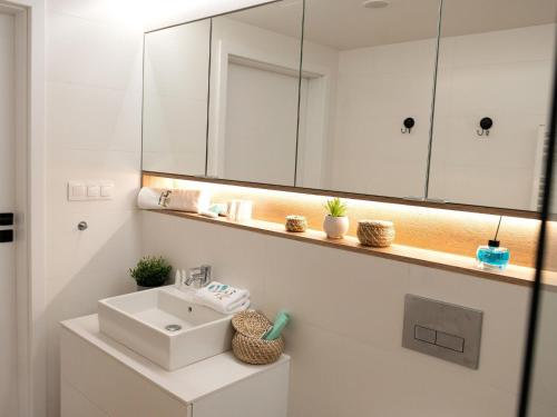 a bathroom with a sink and a mirror at Modern apartment for 5 people, very close to the beach, Pobierowo in Pobierowo