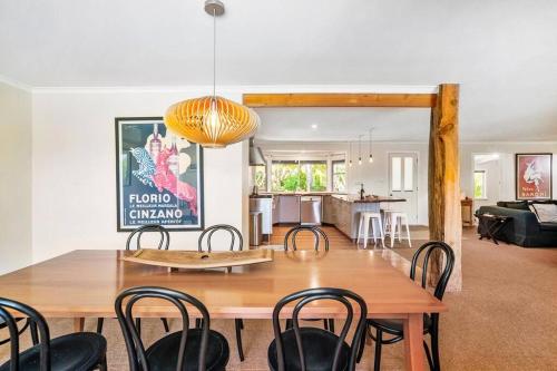 a dining room and living room with a table and chairs at 'The Love Shack' Pet-Friendly Beach Bungalow in Prevelly
